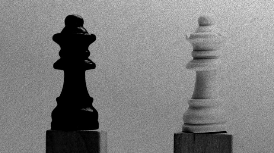 Black and white chess kings representing two holding-company choices