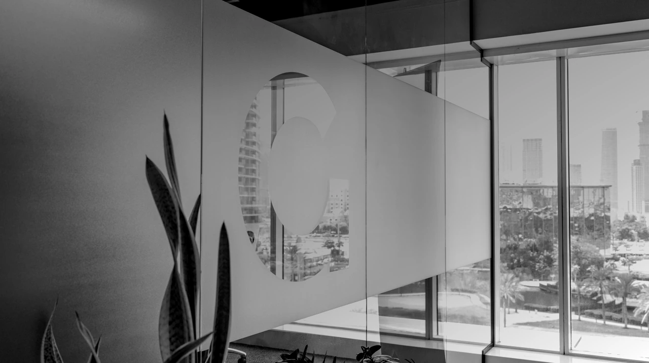 Glass meeting-room door in a corporate office.